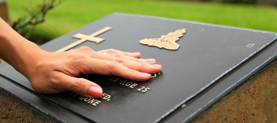 Hand Resting on Grave Marker
